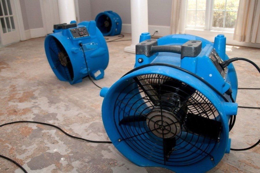 Industrial air movers drying a cleared room down to dry standard